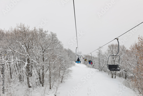 People are lifting on ski-lift in the mountains