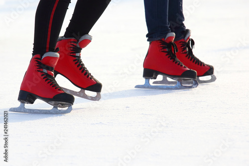 Female legs in skates on an ice rink