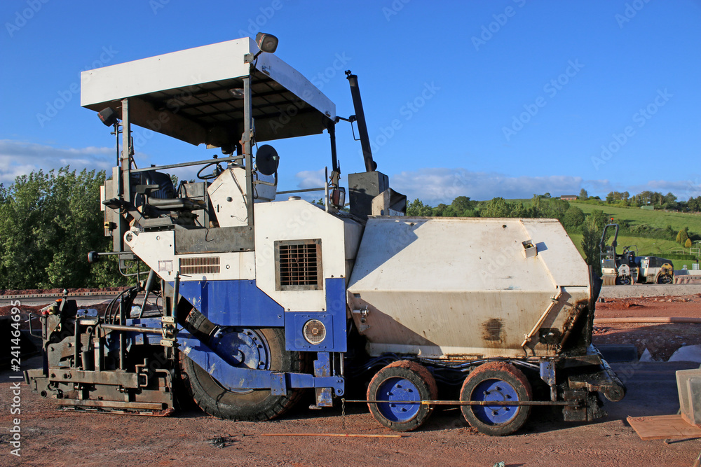 Asphalt paver on a construction site Asphalt paver on a construction site