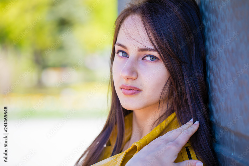 Portrait of young beautiful brunette in yellow jacket Portrait of young beautiful brunette in yellow jacket