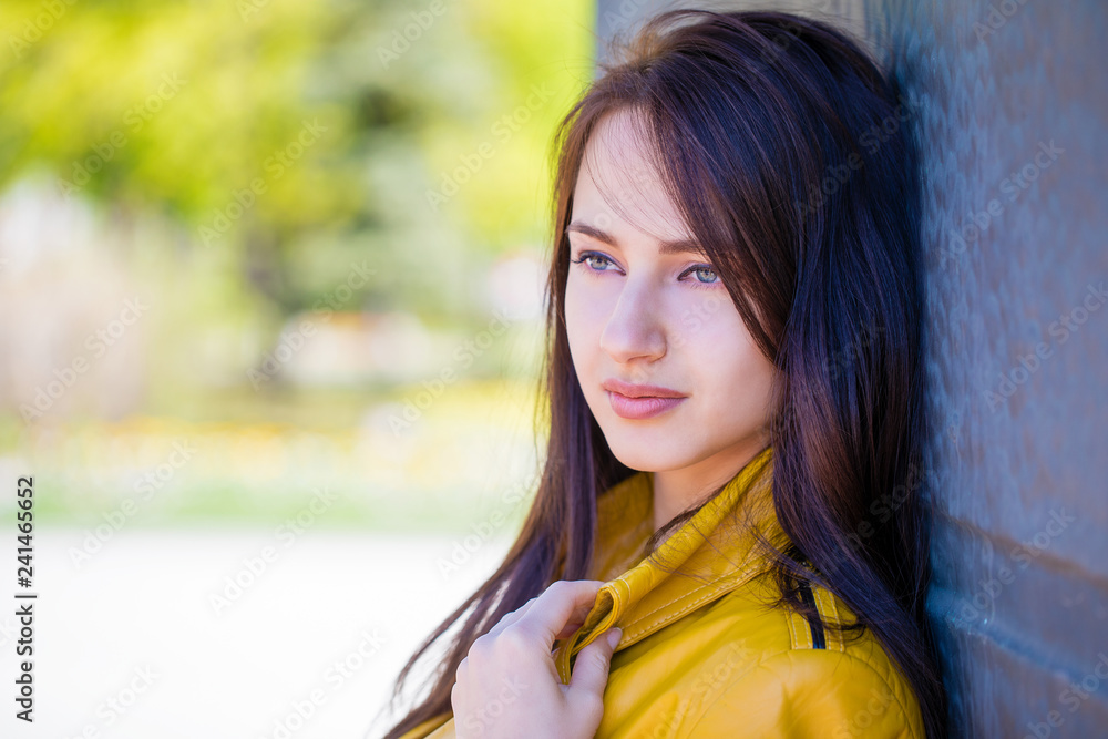 Portrait of young beautiful brunette in yellow jacket Portrait of young beautiful brunette in yellow jacket