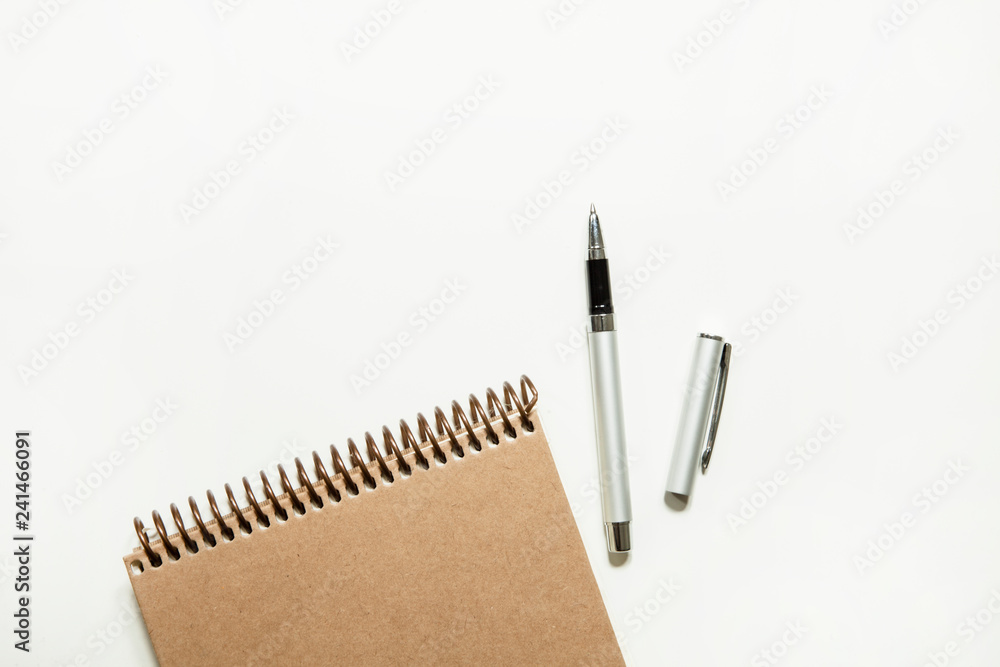 Notebook with pen on white background Notebook with pen on white background