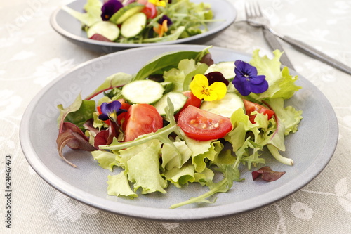 Vegetarian salad with fresh vegetables and flowers.