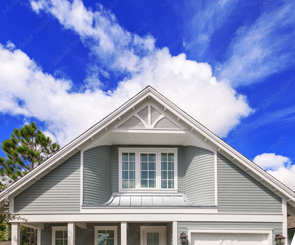 Beautiful Florida home detail with blue sky and clouds in the background