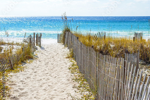 Sandy walkway with picket fence leading to the beach and ocean