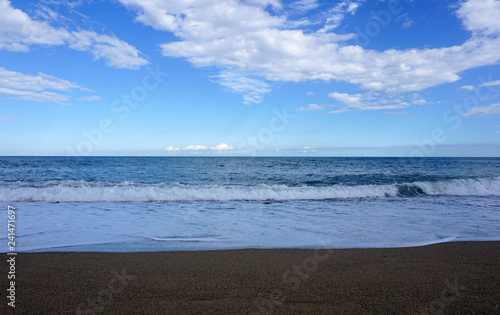 Sea view from beach with sunny sky. Summer paradise beach . Exotic summer beach with clouds on horizon. Ocean beach relax, outdoor travel -