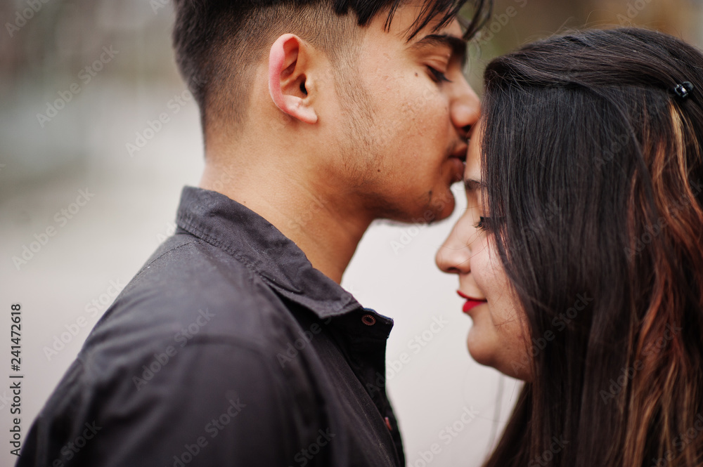 Love story of indian couple posed outdoor kissing. Love story of indian couple posed outdoor kissing.