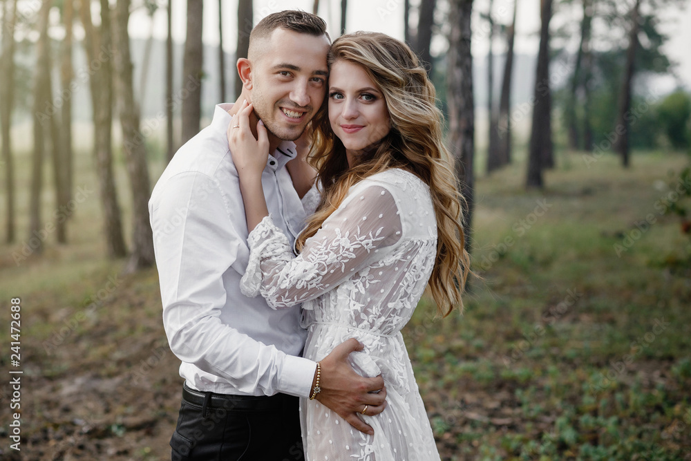 Naklejka premium Happy young couple in love having a good time and embracing in the park.