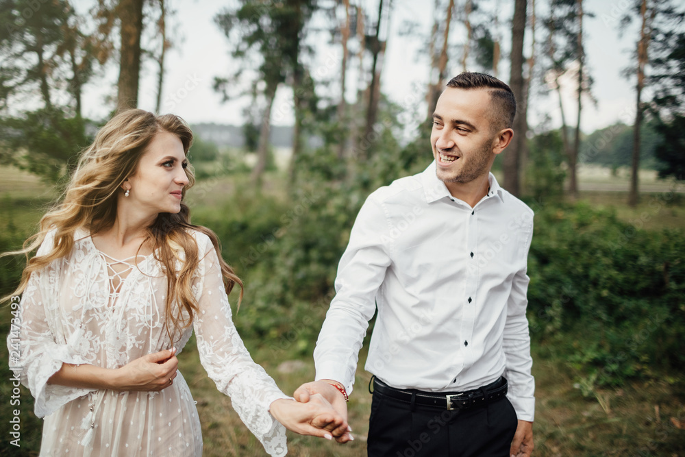Happy young couple in love having a good time and embracing in the park. Happy young couple in love having a good time and embracing in the park.