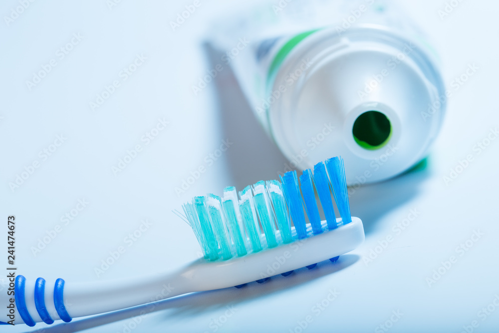 toothbrush and toothpaste tube on blue background toothbrush and toothpaste tube on blue background