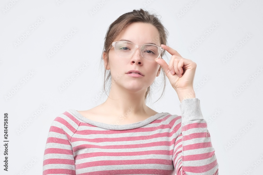Serious european woman wearing big elegant glasses having thoughtful expression. Serious european woman wearing big elegant glasses having thoughtful expression.
