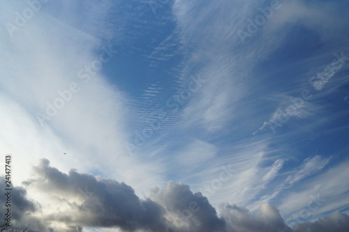 blue cloudy sky with a plane © Matt