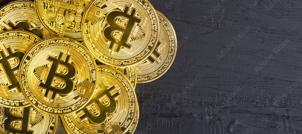 Naklejka premium golden bitcoin stack on the black background