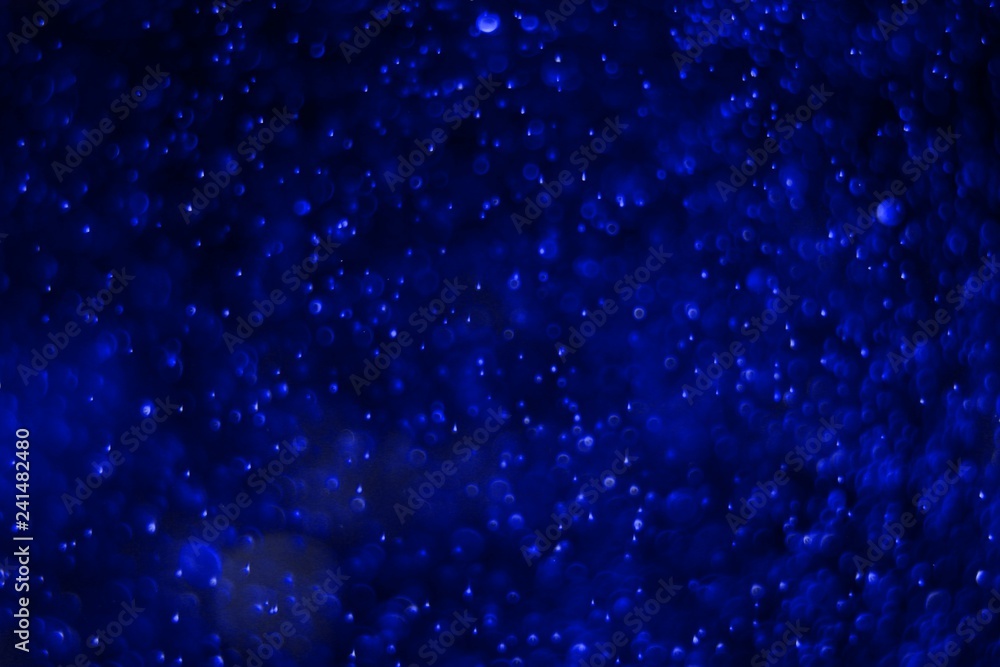 Fototapeta premium blue a lot of flying multi colored lights bokeh texture - cute abstract photo background