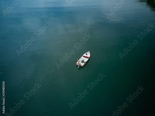 Aerial Drone image of a colorful rowboat just offshore on a Costa Rica Beach © Jorge Moro