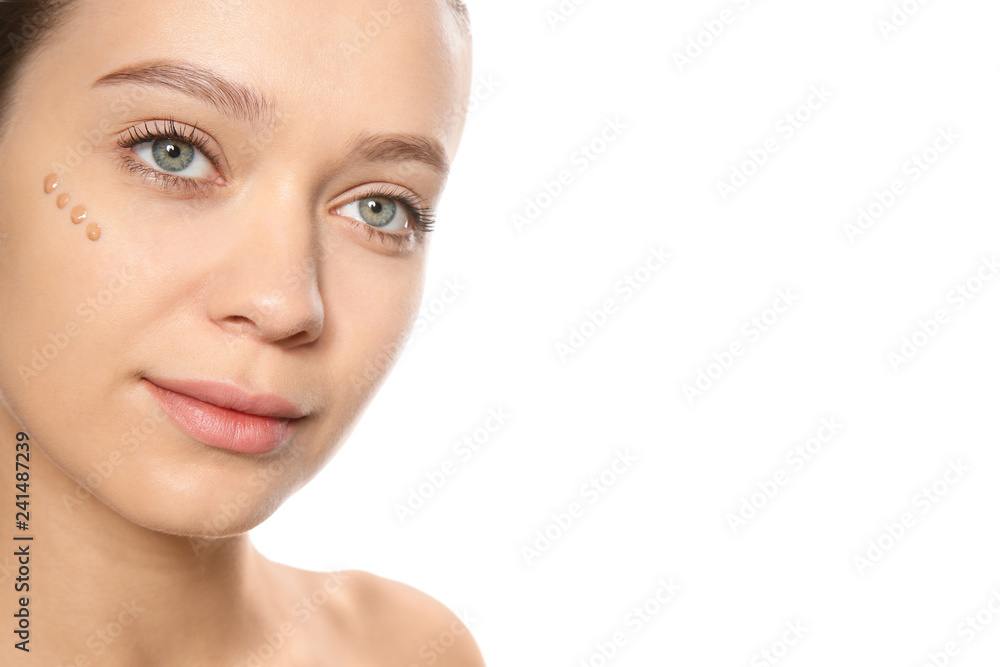 Portrait of young woman with liquid foundation on her face against white background Portrait of young woman with liquid foundation on her face against white background