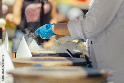 Woman cooking pancakes outdoors