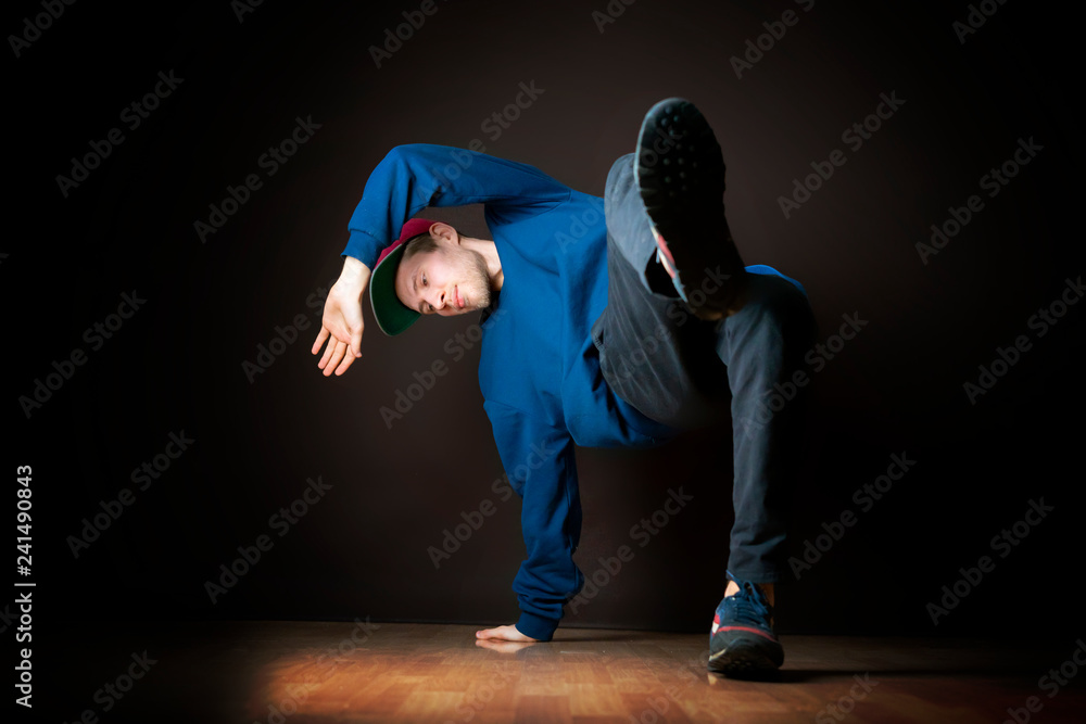 closeup photo of male break dancer performing stance against dark background b closeup photo of male break dancer performing stance against dark background b