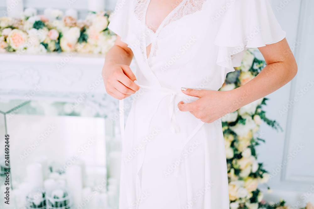 Beautiful brunette in silk robe in her bedroom Beautiful brunette in silk robe in her bedroom