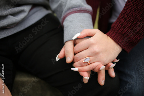 Engagement Photography  Young Newly Engaged Couple Affectionately Embracing and Showing off Engagement Ring
