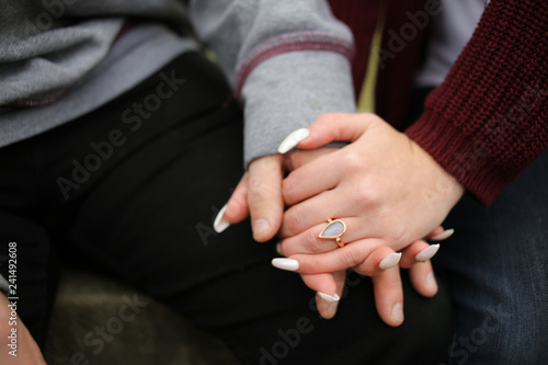Engagement Photography: Young Newly Engaged Couple Affectionately Embracing and Showing off Engagement Ring © holly
