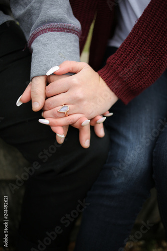 Engagement Photography  Young Newly Engaged Couple Affectionately Embracing and Showing off Engagement Ring
