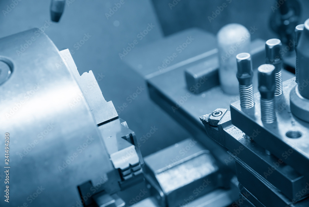 The lathe machine cutting the steel shaft .Metal working in factory. The lathe machine cutting the steel shaft .Metal working in factory.