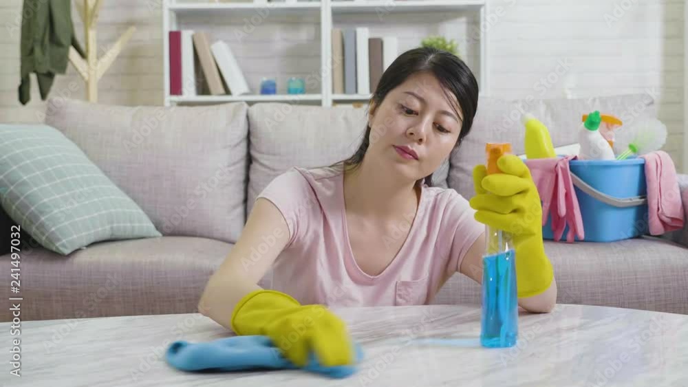 chinese young woman doing cleaning job and feeling bored tired resting head and arms on table sitting on floor in living room. asian housewife housekeeping in gloves. frustrated lady doing much work. chinese young woman doing cleaning job and feeling bored tired resting head and arms on table sitting on floor in living room. asian housewife housekeeping in gloves. frustrated lady doing much work.