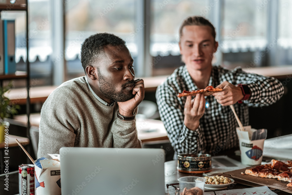 Thoughtful bearded male person touching his chin Thoughtful bearded male person touching his chin