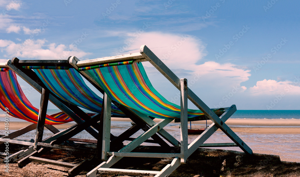 Old wooden beach chair on the beach in the morning for relaxation Old wooden beach chair on the beach in the morning for relaxation