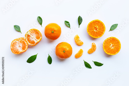 Orange fruits and green leaves on a white background.