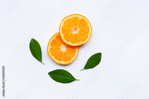 Fresh orange slices, citrus fruits with leaves on white background.