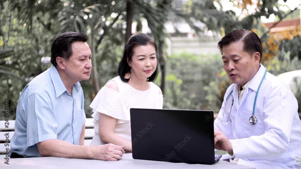 Senior asian medical doctor using laptop discussing health of senior asian couple outdoor in garden. Senior care service concept. Senior asian medical doctor using laptop discussing health of senior asian couple outdoor in garden. Senior care service concept.