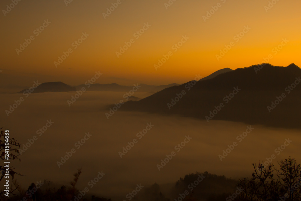 Beautiful sky sunrise. Mountain layer in morning sun ray and winter fog. Beautiful sky sunrise. Mountain layer in morning sun ray and winter fog.
