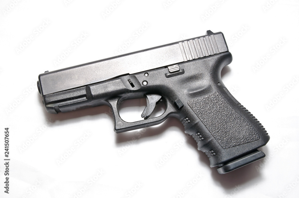 A black semi automatic 9mm pistol on a white background