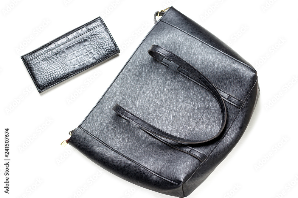 Fashionable black bag and purse close-up, top view, isolated on white background Fashionable black bag and purse close-up, top view, isolated on white background
