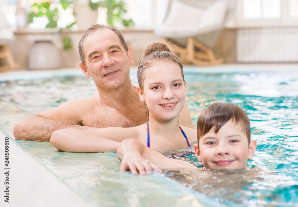 Fototapeta premium Happy family having fun in the pool