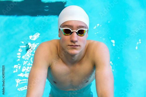 Portrait of a swimmer on the background of the pool. © AnastazjaSoroka
