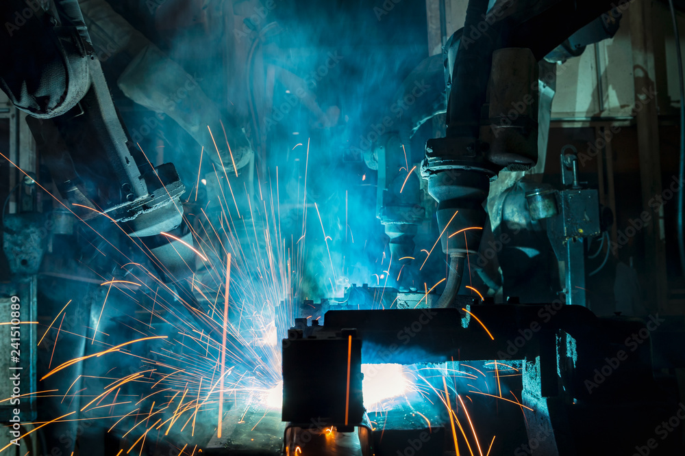 Industrial robot is movement welding steel part in factory Industrial robot is movement welding steel part in factory
