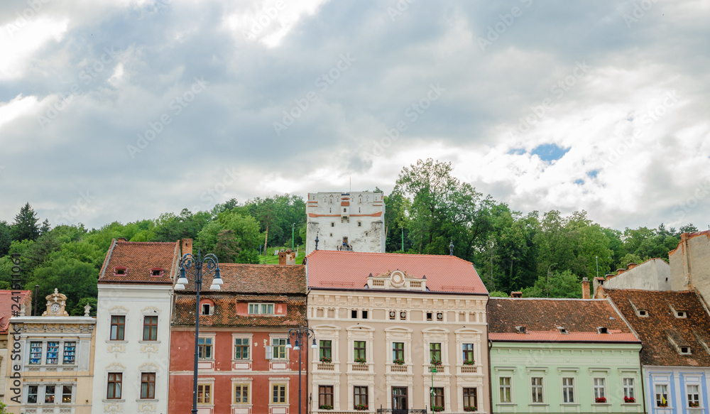 The White Tower with beautiful old historic buildings on the front in Brasov city of Romania