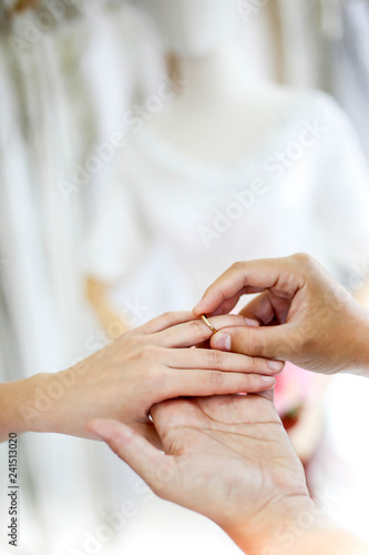 Wedding couple holding hands and put her a wedding ring,