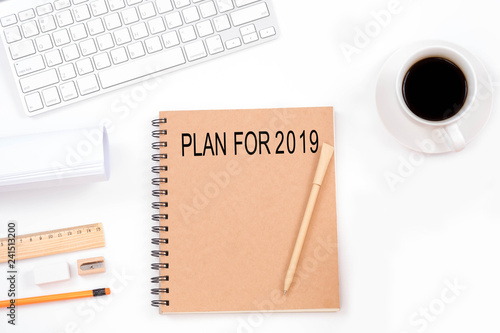 Plan for 2019 word on notebook with modern workplace on white background.