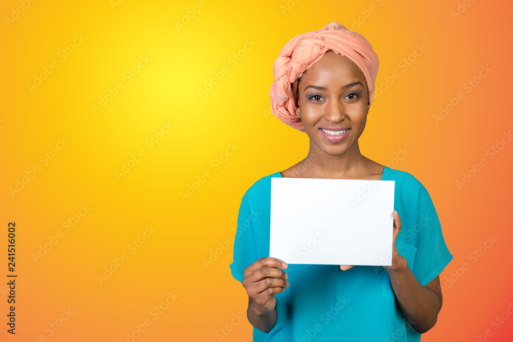 A beautiful woman with a perfect smile holds a business card A beautiful woman with a perfect smile holds a business card