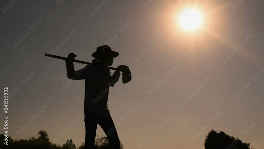 Agriculture life Concept : Black silhouette of a worker holding spade is digging soil at sunset light. Asian farmer holding spade and digging the soil. Agriculture life Concept : Black silhouette of a worker holding spade is digging soil at sunset light. Asian farmer holding spade and digging the soil.