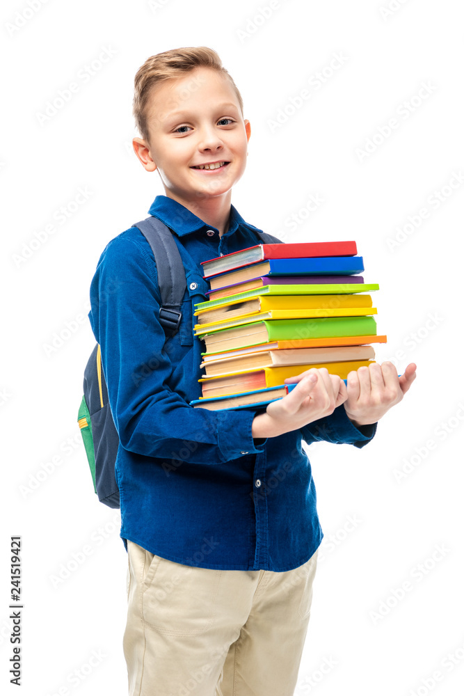 cute boy with backpack holding stack of books and looking at camera isolated on white cute boy with backpack holding stack of books and looking at camera isolated on white
