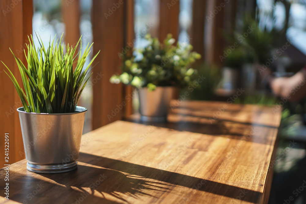 Fototapeta premium A flower vase placed on a table in a coffee shop on a chill day