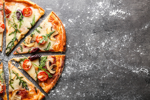 Delicious pizza on grey background photo