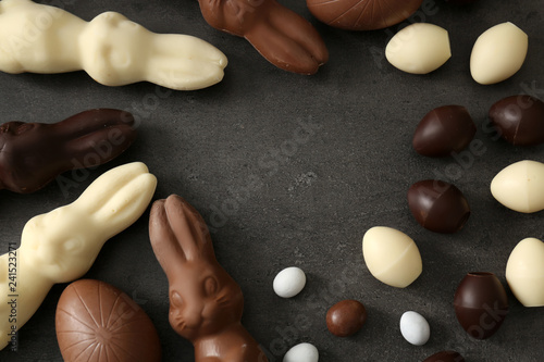 Chocolate Easter eggs and bunnies on grey background