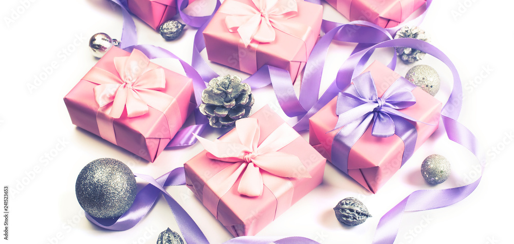 Banner Christmas boxes with gifts on the occasion of pink color on white background cones nuts decor Top view flat lay horizontal Selective focus
