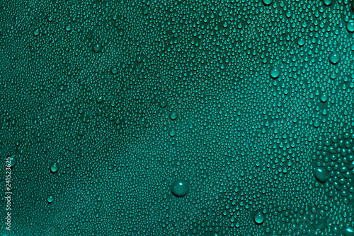 Abstract bright water drops texture on green blue cyan background